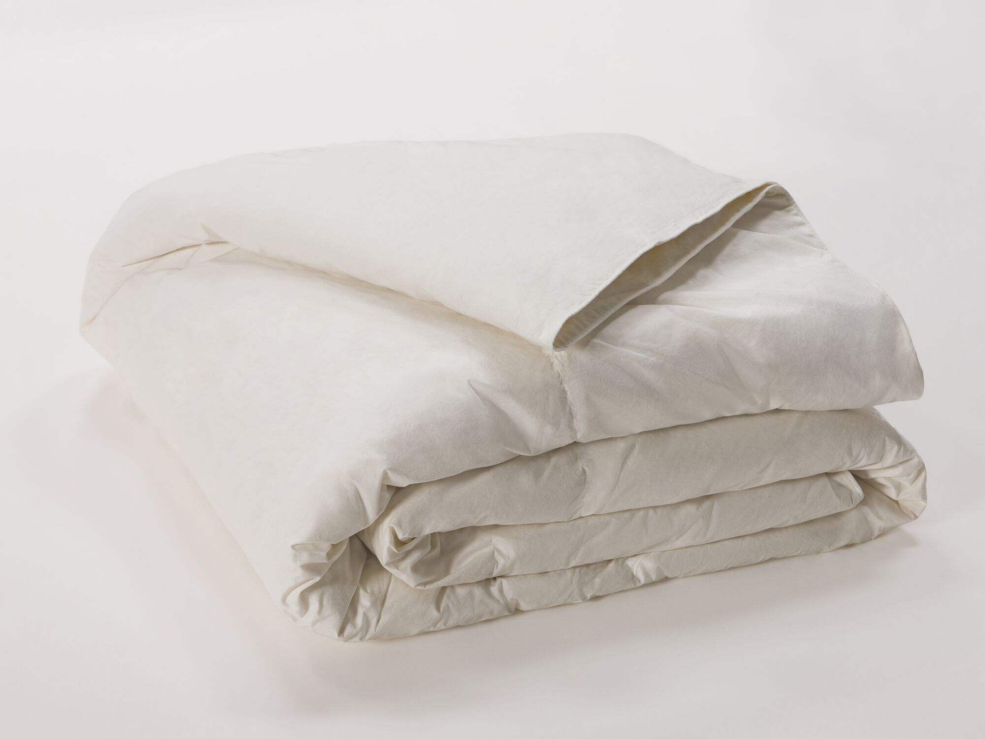 Detail view of folded ivory down duvet